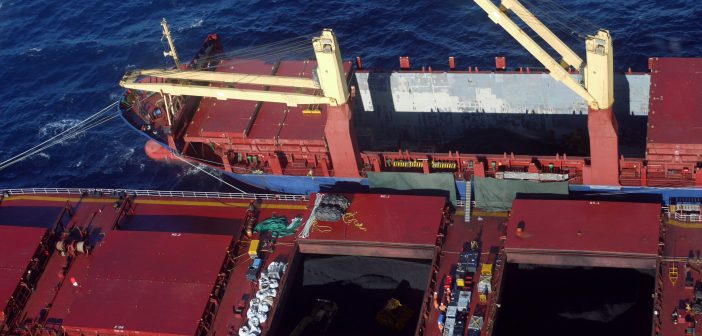 Coal being removed from the Chinese-registered stricken bulk carrier Shen Neng 1